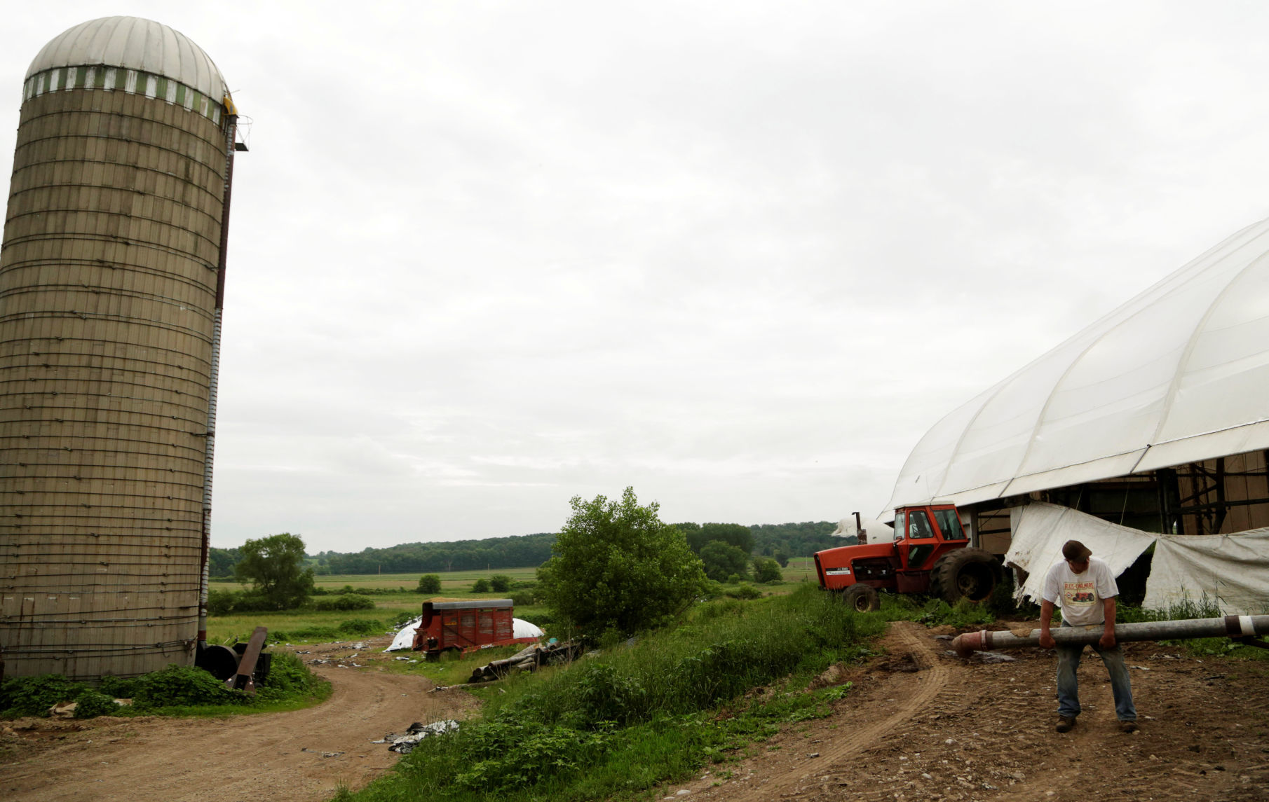 Gordon A. Giese and his son Paul Giese get ready to fill a manure tank at the family farm, God Green Acres in Mayville